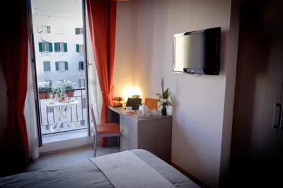 a bedroom with a bed and a window with a desk at Castellani A San Pietro in Rome