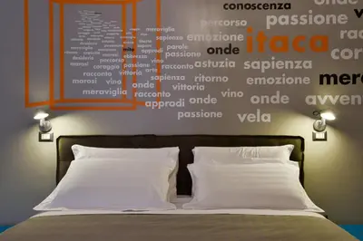 a bedroom with a bed with a wall with words on it at The Pope's Window in Rome