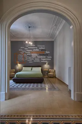 a bedroom with a bed with a wall with words on it at The Pope's Window in Rome