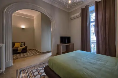 a bedroom with a bed and a window and a couch at The Pope's Window in Rome