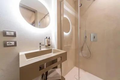 a hotel room with a bed and a desk at San Carlo Suite in Rome