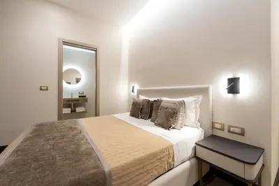 a bedroom with a bed and a flat screen tv at San Carlo Suite in Rome