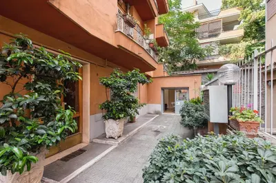 an alley with potted plants on the side of a building at B&B Blueberry Rooms in Rome