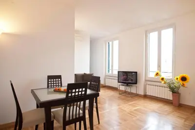 a living room with a table and chairs and a television at Romacentrarte in Rome