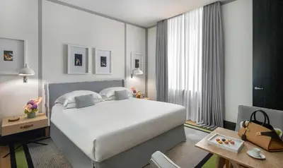 a bedroom with a large white bed in a room at Portrait Roma - Lungarno Collection in Rome