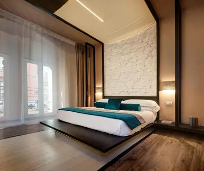 a bedroom with a large bed with blue pillows at Dharma Luxury Hotel & SPA in Rome