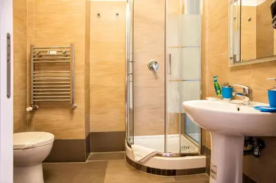 a bathroom with a shower and a toilet and a sink at The Colours Of Rome in Rome