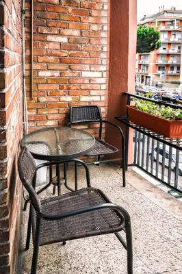 a patio with two chairs and a table on a balcony at The Colours Of Rome in Rome