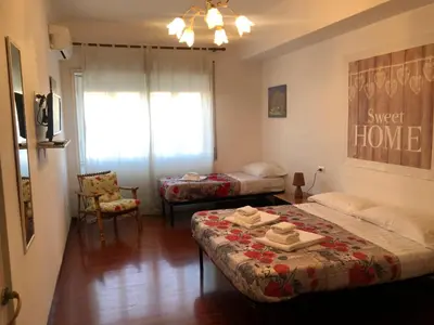 a small room with a bed and a couch at The Colours Of Rome in Rome