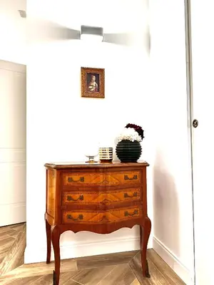 a chest of drawers in a room with a white wall at All Comfort Astoria Palace in Rome