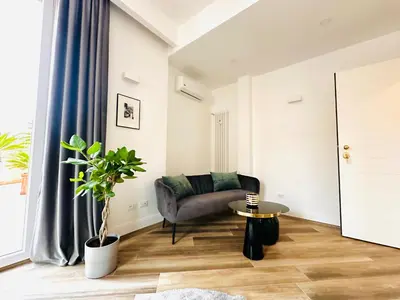 a living room with a couch and a table at All Comfort Astoria Palace in Rome