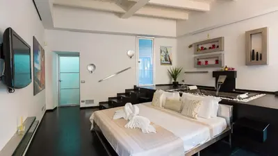 a bedroom with a large bed with white sheets at Rental in Rome Cosmopolitan hi-tech in Rome