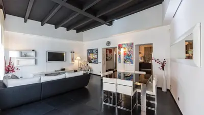 a living room with a couch and a tv at Rental in Rome Cosmopolitan hi-tech in Rome