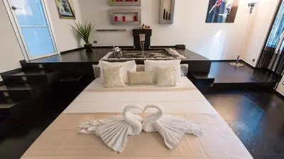 two white swans forming a heart on a bed in a room at Rental in Rome Cosmopolitan hi-tech in Rome