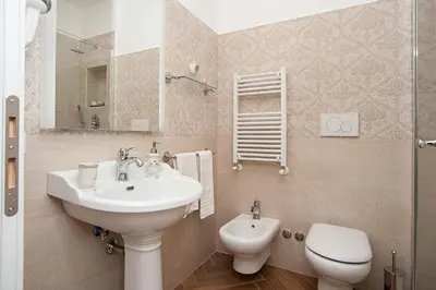 a bathroom with a sink and a toilet at Luxury & Charme Colosseo in Rome