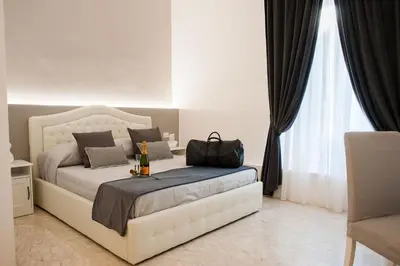 a bedroom with a bed with a bottle of wine on it at Lifestyle Veneto Suite in Rome