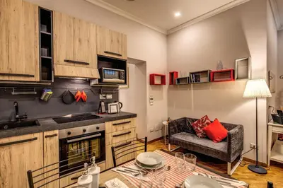 a kitchen with a couch and a table in a room at Appartamento via del Pantheon in Rome
