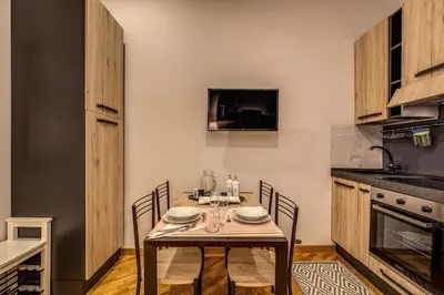 a dining room with a table and chairs in a kitchen at Appartamento via del Pantheon in Rome