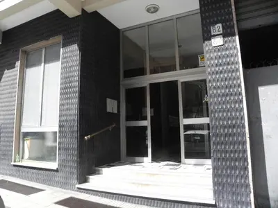 a black brick building with a glass door at Vatican 84 in Rome