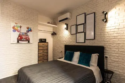 a bedroom with a bed and a brick wall at Trevi & Pantheon Design Rooms in Rome