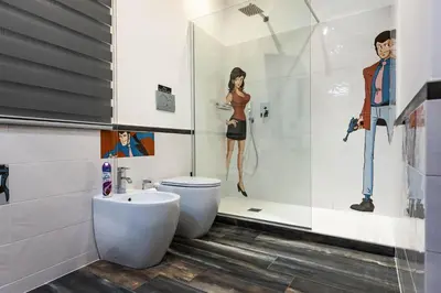 a bathroom with a toilet and a woman in a shower at Trevi & Pantheon Design Rooms in Rome