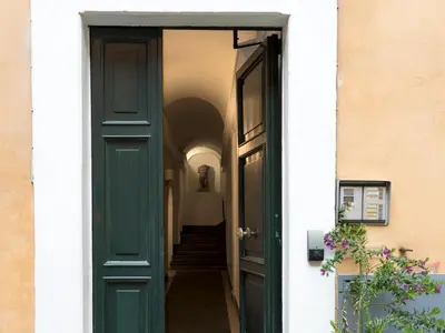 a green door leading into a hallway at IG Suites in Rome