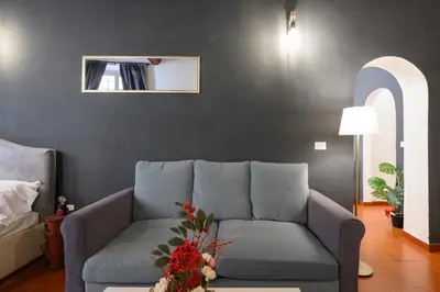 a living room with a couch and a window at Monserrato Apartment in Rome