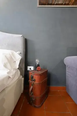a room with a bed and a chest next to a bed at Monserrato Apartment in Rome