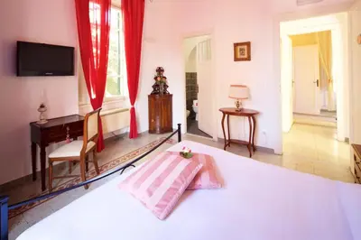 a bedroom with a bed and a desk and a television at Il Tempio di Morfeo in Rome