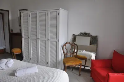 a bedroom with a bed and a red couch at Interno 7 in Rome