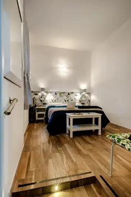 a bedroom with a bed and a laptop on a table at Vatican36 Guest House in Rome