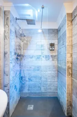 a bathroom with a shower with a glass door at Vatican36 Guest House in Rome