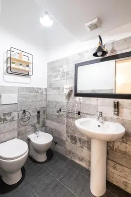a bathroom with a toilet and a sink and a mirror at Vatican36 Guest House in Rome