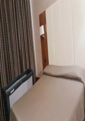 a small bedroom with two beds and a window at Federica's Home in Rome