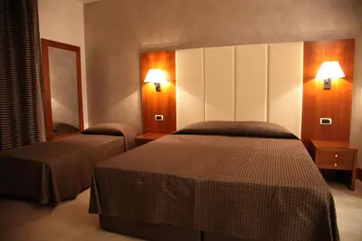 a hotel room with two beds and two lights at Federica's Home in Rome