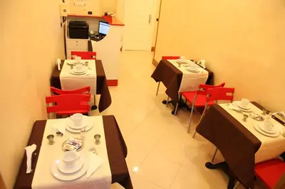 a dining room with tables and red chairs at Federica's Home in Rome