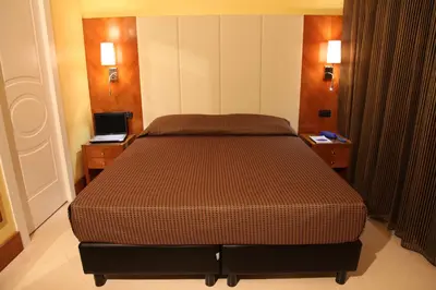 a bed in a room with two nightstands and a bed sidx sidx sidx at Federica's Home in Rome