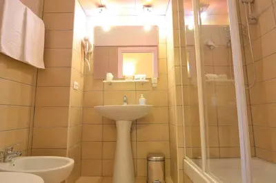 a bathroom with a sink and a toilet and a mirror at Vatican Town in Rome