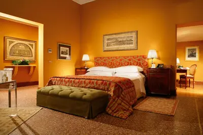 a hotel room with a bed and a chair at Villa Spalletti Trivelli - Small Luxury Hotels of the World in Rome