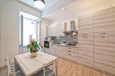 a kitchen with a table with a potted plant on it at Casa Fabio in Rome