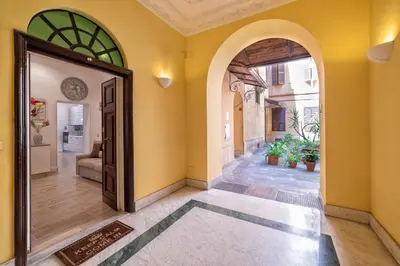an empty hallway with an archway and a door at Casa Fabio in Rome