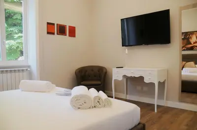a hotel room with two beds and a flat screen tv at Nomentana House in Rome