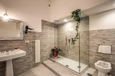 a bathroom with a tub and a sink and a toilet at Feronia Guest house in Rome