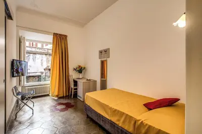 a hotel room with a bed and a window at Feronia Guest house in Rome