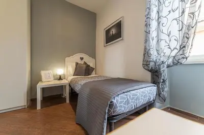 a small bedroom with a bed and a window at Be My Guest in Rome