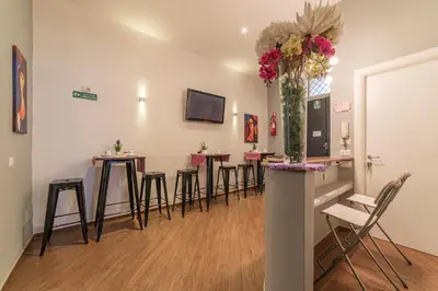 a group of stools in a room with a bar at Be My Guest in Rome