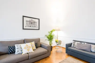 a living room with two couches and a plant at Suite 06 in Rome