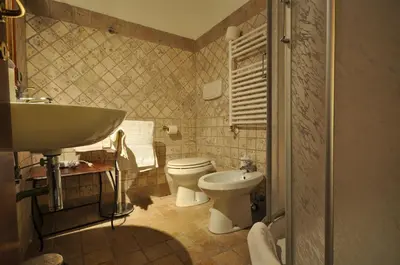 a bathroom with a toilet and a sink at Casale De Santis in Rome