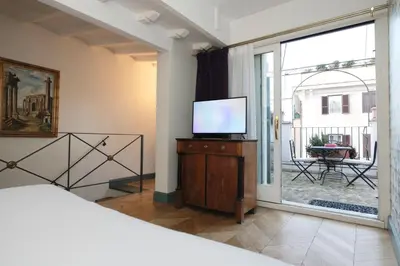 a bedroom with red walls with a bed and a desk at Boutique Hotel Anahi in Rome