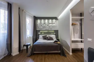 a bedroom with a bed and a large window at Z-ArchSuites in Rome